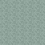 A repeating botanical pattern of small green leaves on a muted sage green background, with a measuring ruler along the bottom edge showing scale.