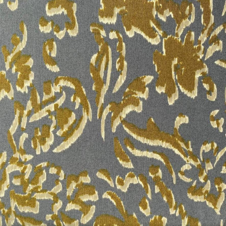 Grey cotton fabric with abstract gold and cream floral print, 110cm wide.