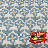 Hanako cotton printed poplin fabric with blue and yellow floral pattern on a light background.
