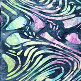 A close-up of a fabric or scarf with a dark navy blue background and a swirling, marbled pattern in light green, purple, and blue. A brown patterned fabric strip is visible on the right side.
