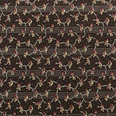 A close-up of a dark brown patterned fabric or wallpaper featuring a repeating floral and vine motif in cream, red, and muted blue, with a decorative border visible along the left edge.