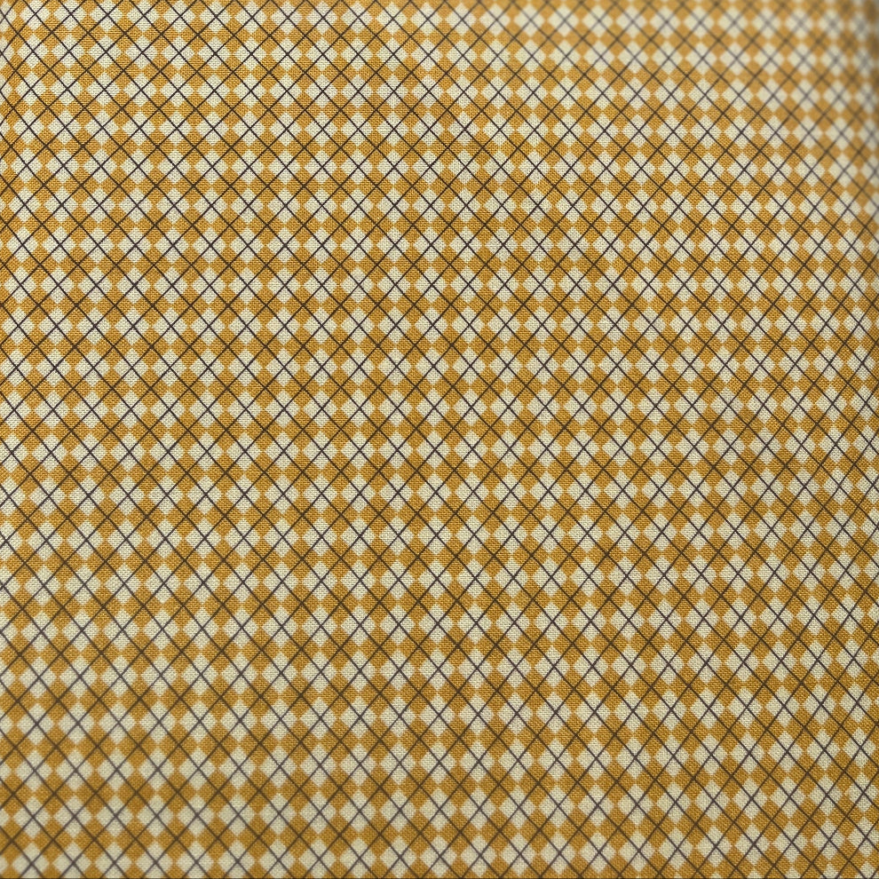 Close-up of a patterned tie with a geometric design on a plain background