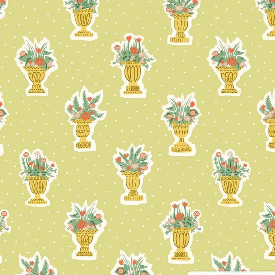 Light green fabric with a repeating pattern of gold vases holding colorful floral arrangements.