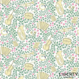 Liberty Garden Party L01667337C fabric: cream musical instruments on a white background with pink flowers and green vines.