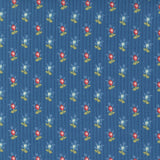 A repeating pattern of small red and white flowers with yellow-green leaves on a textured blue background.