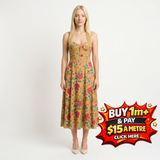 Blonde woman in a mustard yellow midi dress with red and pink floral print, sweetheart neckline, and corset bodice.