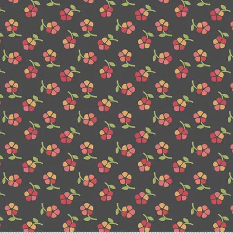 Dark gray fabric with a repeating pattern of small red and yellow flowers with green stems.