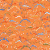Orange Robert Kaufman Dino Darlings cotton fabric with colorful dinosaur patterns.