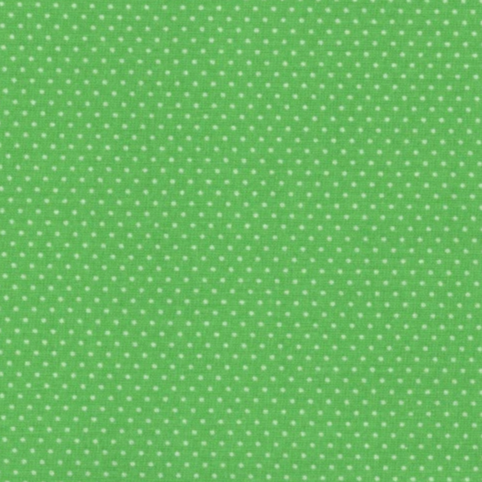 A close-up of a green fabric with a repeating pattern of small white polka dots.