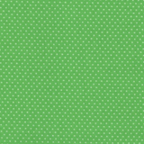 A close-up of a green fabric with a repeating pattern of small white polka dots.