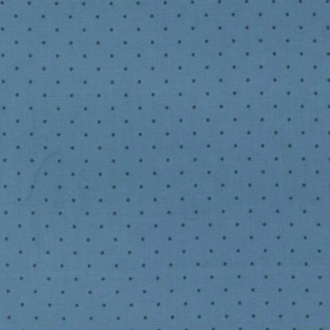 A close-up of a blue fabric or material surface with a repeating small dark polka dot pattern.