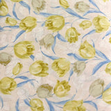Sevenberry Tulip Cotton Print fabric with yellow and pale blue tulips on a light pink background.