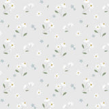 A repeating floral pattern featuring small white daisy-like flowers with yellow centers, green stems and leaves, and scattered pale blue blossoms on a light gray background.