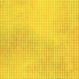 A close-up of a yellow textured surface with a uniform grid of small circular dots, creating a halftone pattern.