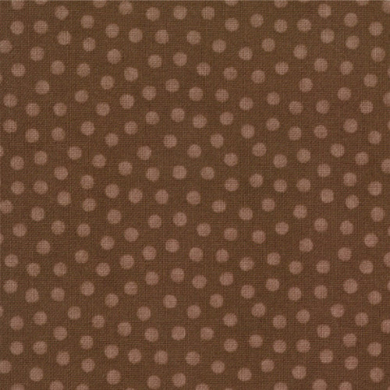 A close-up of a brown fabric with a repeating pattern of small, evenly spaced dusty pink polka dots.