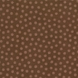 A close-up of a brown fabric with a repeating pattern of small, evenly spaced dusty pink polka dots.