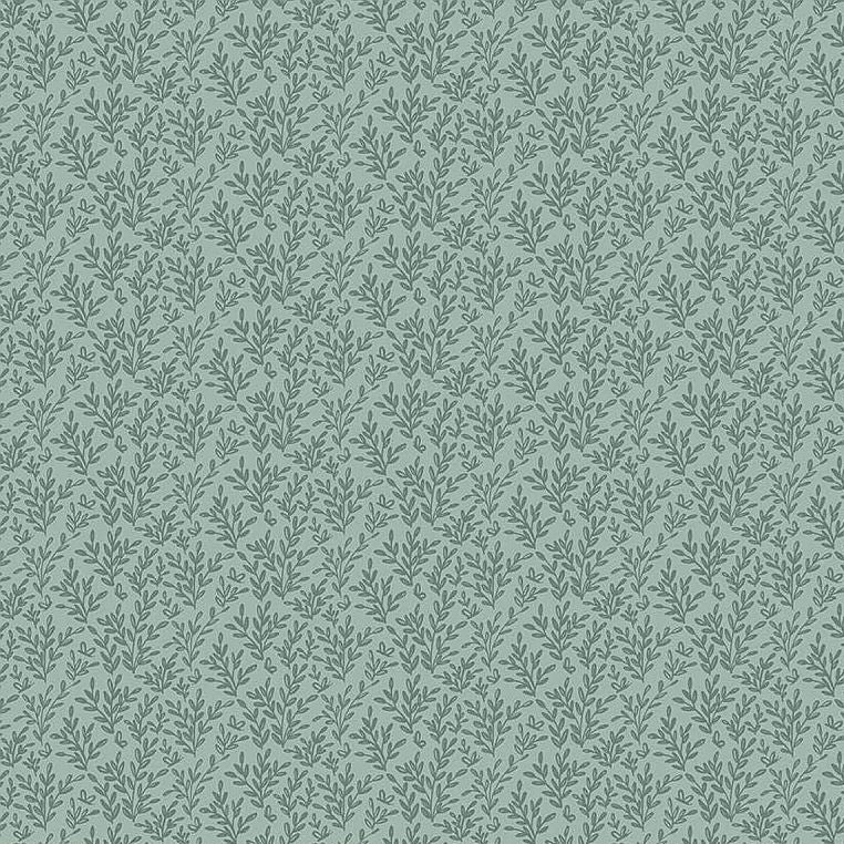 A repeating botanical pattern of small green leaves on a muted sage green background, with a measuring ruler along the bottom edge showing scale.