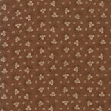 A close-up of a brown fabric or wallpaper pattern featuring a repeating design of small beige flowers, dark brown thistle-like accents, and tiny white dots.