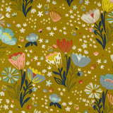 A close-up of a fabric or wallpaper pattern featuring a mustard yellow background with a whimsical, hand-drawn style floral print in blue, pink, red, and white.