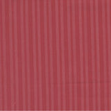 A close-up of a dusty rose red fabric with fine vertical stripes, featuring a white ruler at the bottom edge for scale with the Moda Fabrics logo.