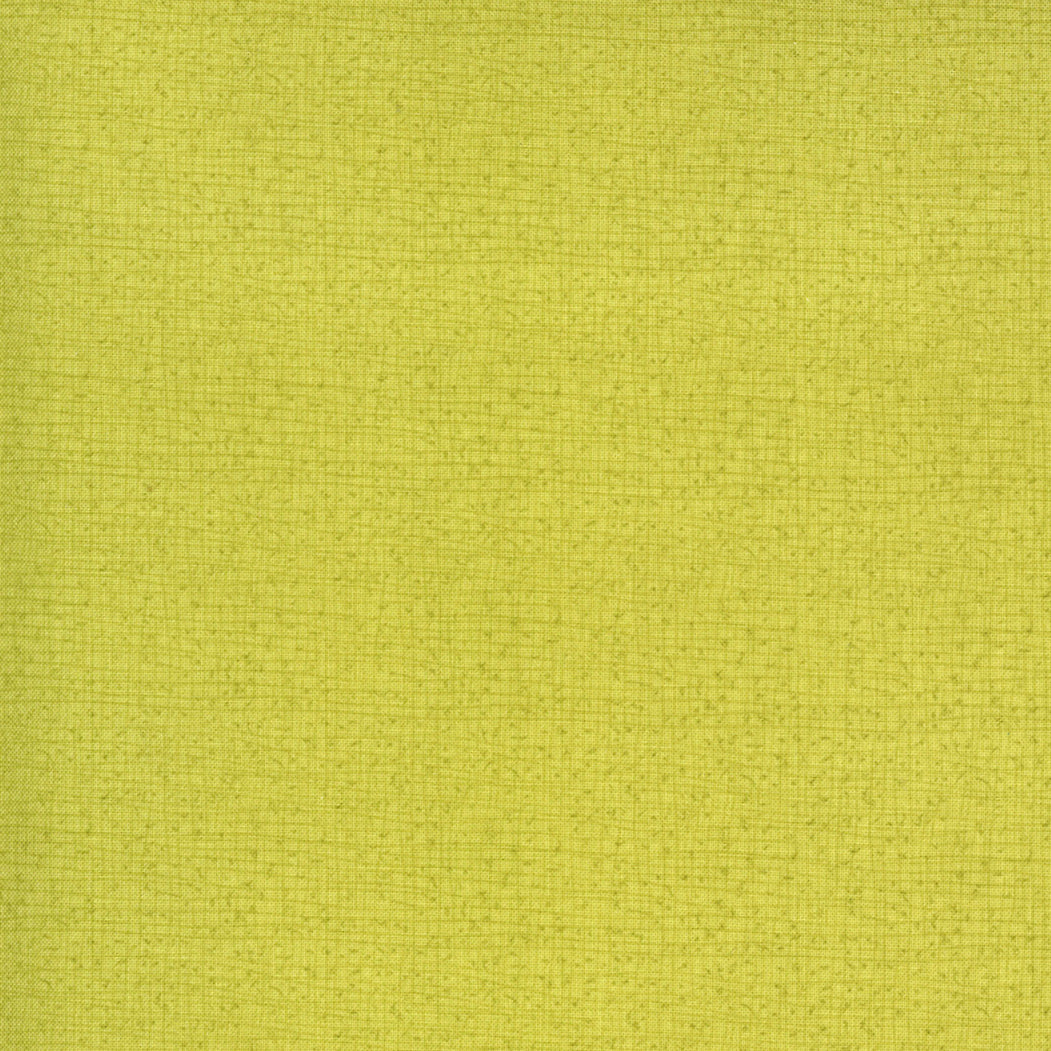 A close-up of a textured fabric swatch in a solid light yellow-green color.