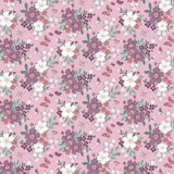 A repeating floral pattern on a dusty pink background with purple and white flowers, green leaves, and small butterflies. A ruler along the bottom edge shows the scale of the print.