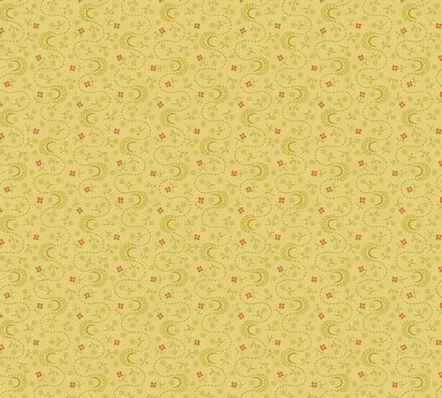 A close-up of a fabric pattern showing a repeating small beige and cream geometric motif, with a measuring ruler along the bottom edge and Andover Fabrics branding visible.