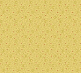 A close-up of a fabric pattern showing a repeating small beige and cream geometric motif, with a measuring ruler along the bottom edge and Andover Fabrics branding visible.