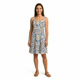 Woman in a white cotton printed lawn dress with blue, pink, and green floral patterns.