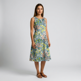 Woman in a sleeveless, knee-length cotton dress with a vibrant floral print in blue, green, and pink.