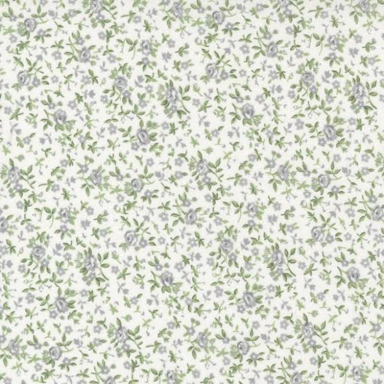 A repeating floral pattern featuring small lavender-gray flowers and green leaves on a warm off-white background.