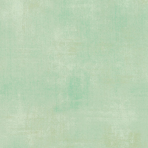 A square color swatch showing a textured, distressed mint green surface with subtle variations in tone.