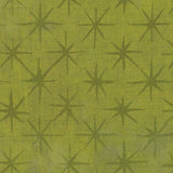 A close-up of a fabric or wallpaper pattern featuring a repeating dark olive green eight-pointed starburst on a textured yellow-green background.