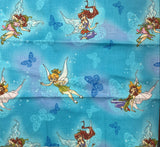 Fabric with fairy and butterfly pattern on a blue background