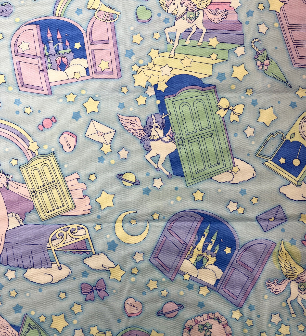Children's paper with unicorn, castle, and rainbow illustrations on a blue background.