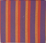 Striped fabric sample on a white sheet with a wooden surface and papers in the background