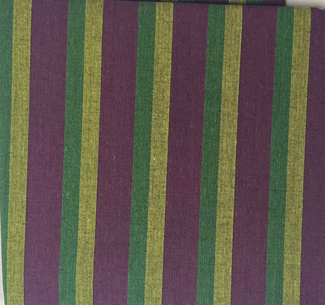 Striped fabric sample on a white sheet with a wooden surface underneath