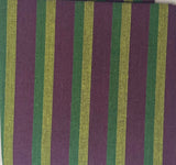 Striped fabric sample on a white sheet with a wooden surface underneath