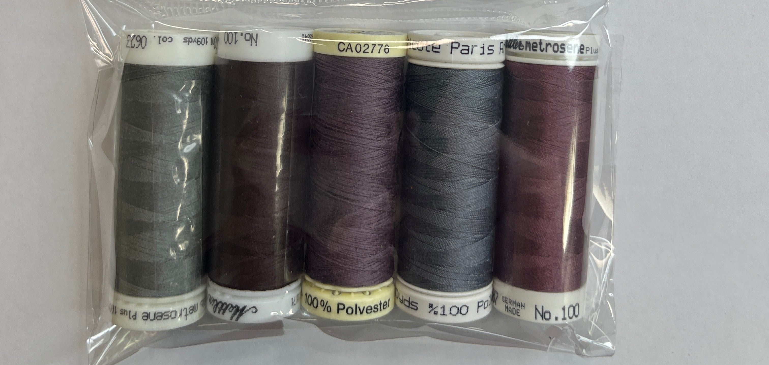 Pack of sewing threads with a label on a white background