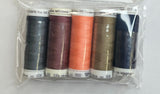 Set of sewing threads in a clear package on a white surface