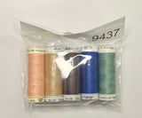 Set of thread spools in a clear package on a wooden surface