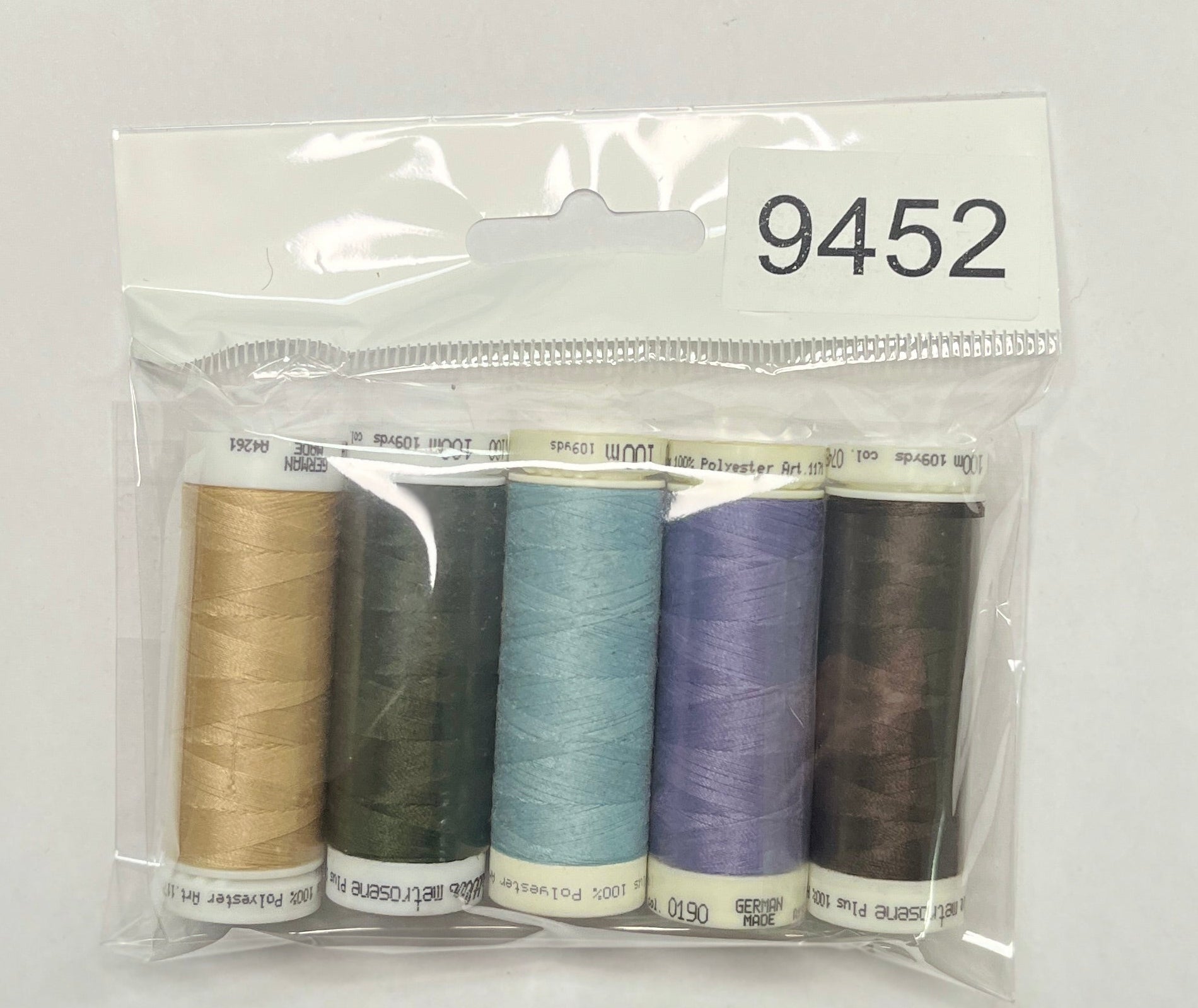 Set of sewing threads in a clear package on a wooden surface