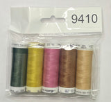 Set of thread spools in a clear package on a wooden surface