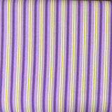 A folded piece of fabric with a purple, white, and lime green striped pattern, laid flat on a dark wood surface.