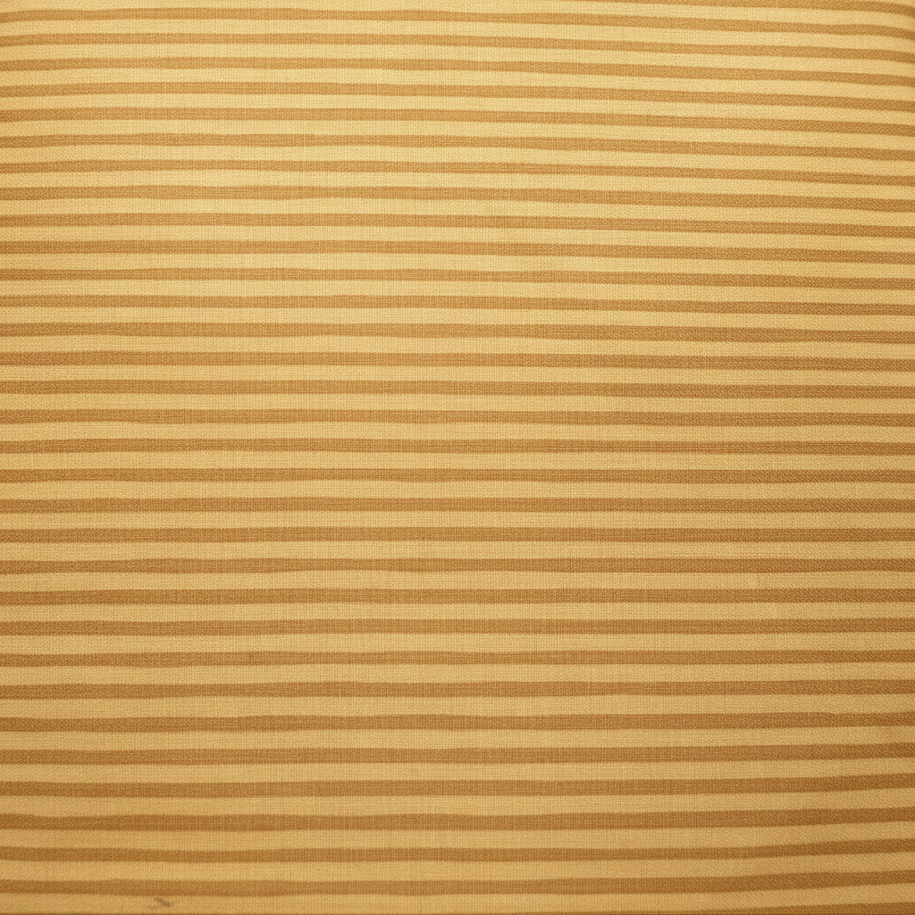 A close-up of a beige and brown horizontally striped fabric draped over a dark wooden surface, with a floral-patterned fabric and other items partially visible in the background.