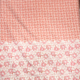 A long rectangular textile item, likely a scarf or bandana, featuring a split design: a fine coral-red geometric pattern on the upper half and a larger pink floral motif on a white background on the lower half.