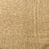 Close-up of a textured beige box with a brand label on a white background