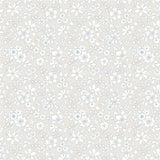 A repeating floral pattern with small white and light blue flowers on a warm light beige background.