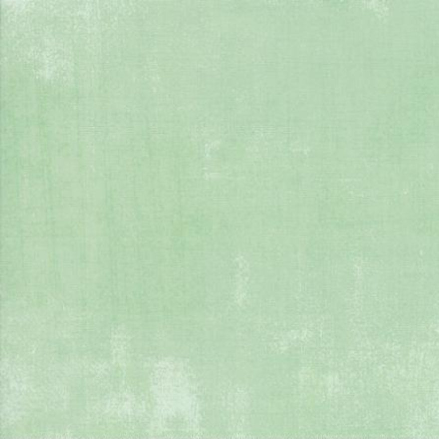 Solid light green fabric swatch with a ruler at the bottom