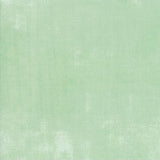 Solid light green fabric swatch with a ruler at the bottom